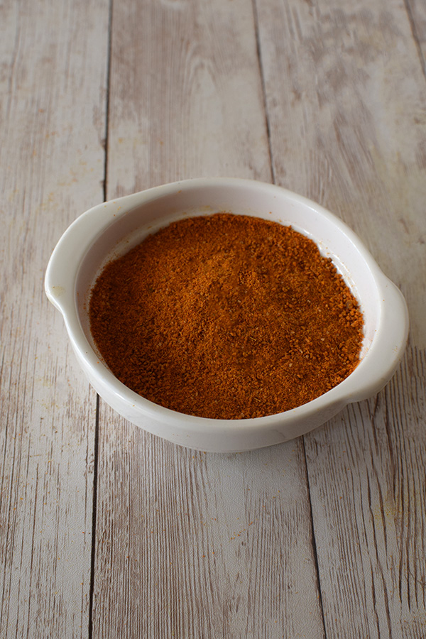Easy Israeli Grill chicken powder in a white bowl on a white board background