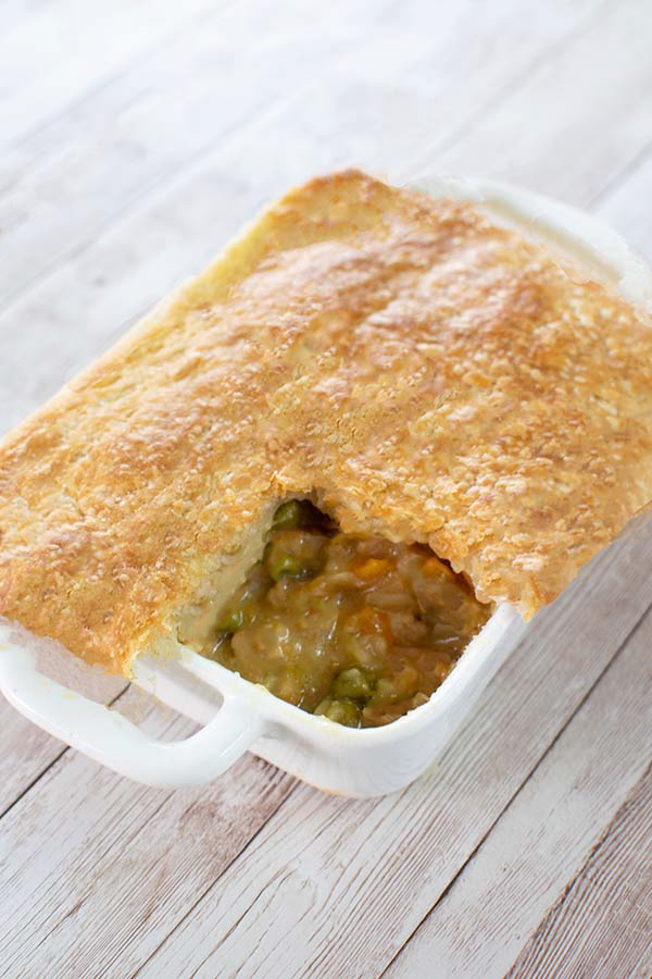 Easy beef pot pie in a white rectangular dish on a white wood background