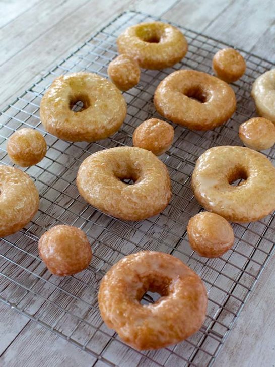 Dairy Free Doughnuts Glazed and glazed doughnut holes on a cooling rack