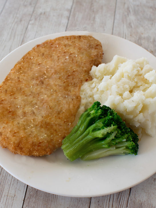 Schnitzel for passover on a plate with mashed potatoes and broccoli