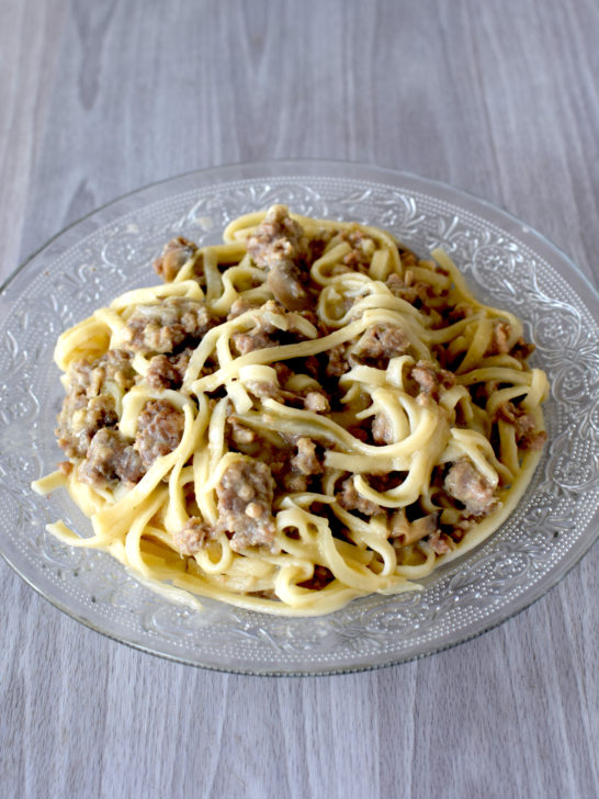 Easy Dairy-Free Ground Beef Stroganoff in a clear bowl on a white wooden table.