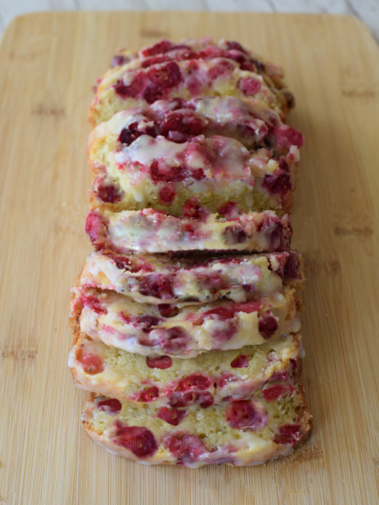 Easy Diary-Free Cranberry-Orange Loaf Cake on a cutting board.