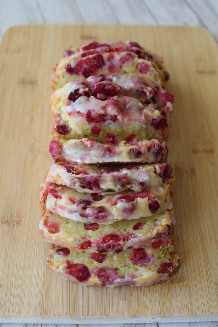 Easy Diary-Free Cranberry-Orange Loaf Cake on a cutting board.