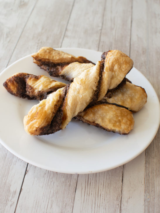 Easy Chocolate Pastry Twist Sticks on a white plate on a white wood table