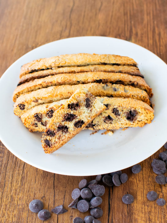 Easy dairy-free chocolate chip biscotti on a white plate on a dark wood table