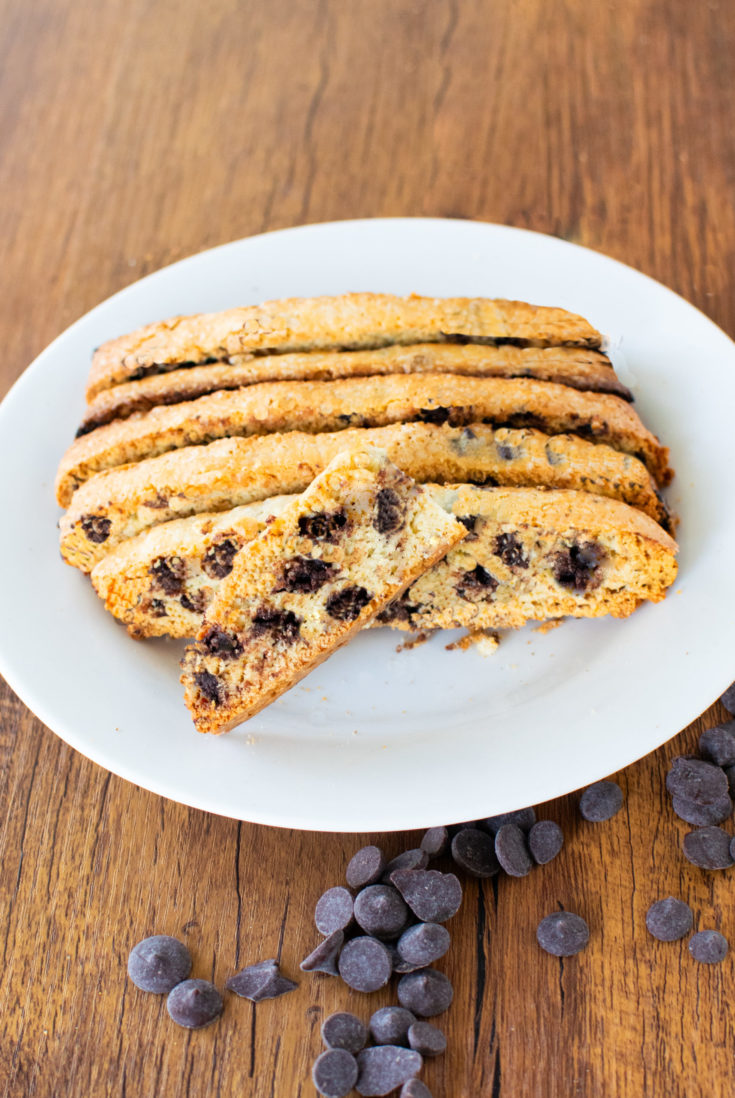 Easy dairy-free chocolate chip biscotti on a white plate on a dark wood table