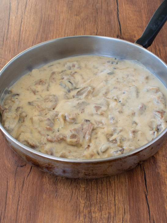 Easy dairy free beef stroganoff in a pan on a dark wood background